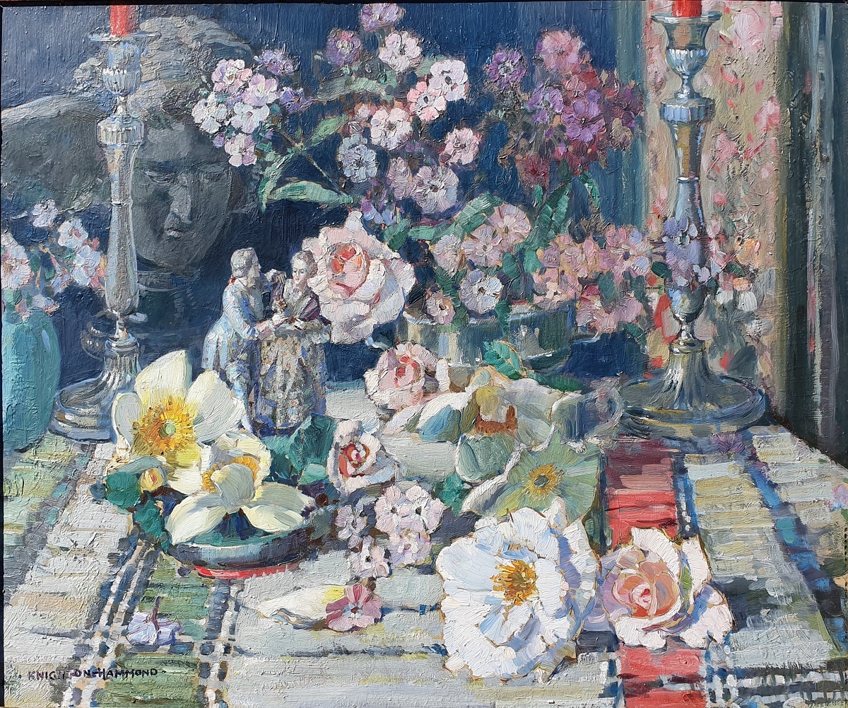 A summer still life with flowers and silverware upon a patterned cloth